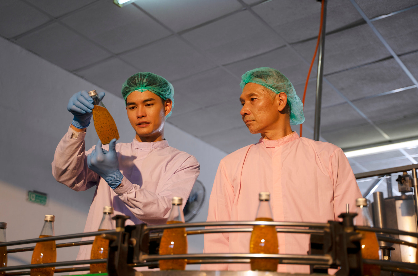 Employees in beverage line factory. Factory and quality control concept.